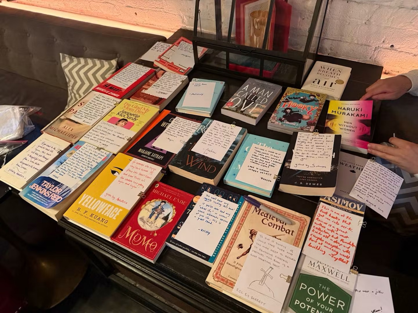 Gift books with handwritten notes laid out at Vol. 1